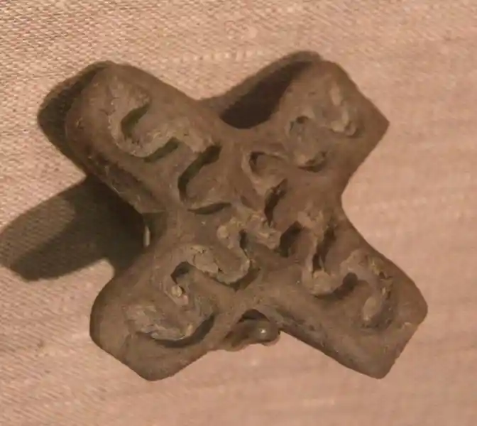 Cross shaped stamp with swastika design inside